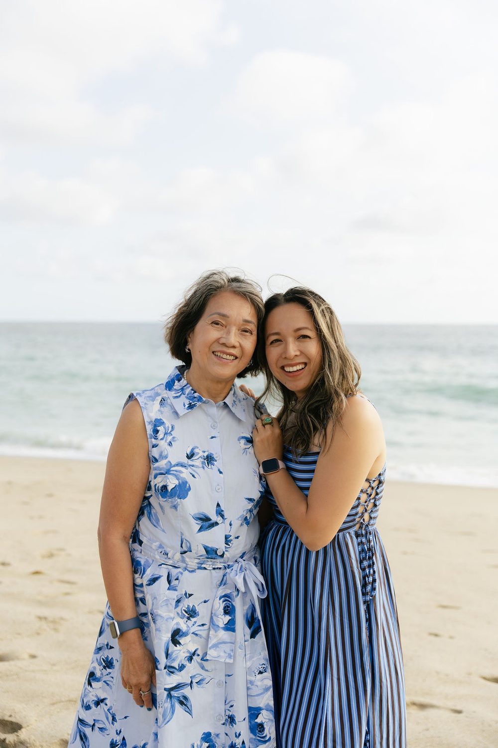 Carol Tran Reynolds hugging her mom on the beach, both smiling