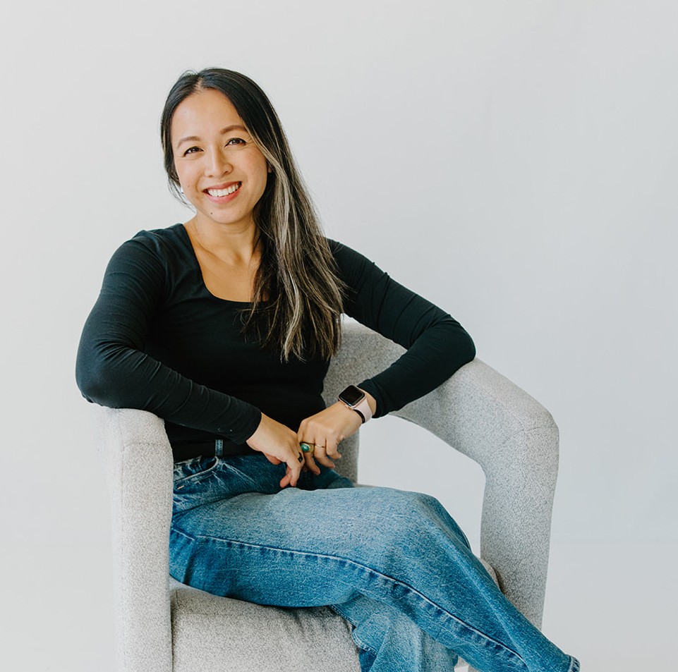 Carol Tran Reynolds, Realtor with Keller Williams Platinum Partners, seated and smiling