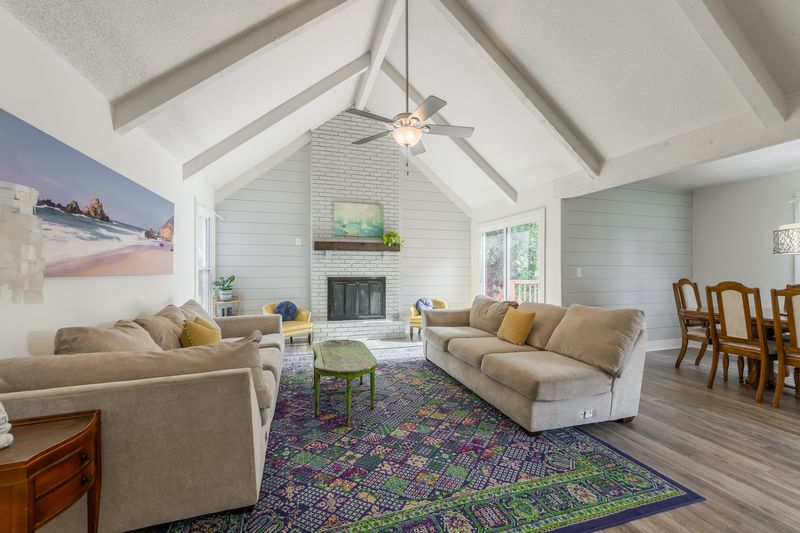 Vaulted living room with brick fireplace at 6613 E 123rd Ter, Grandview, MO, a home sold by Carol Tran Reynolds